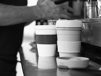 black and white photo of resuable coffee cups